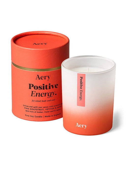 Orange Positive Energy candle by Aery displayed next to product packaging on white background