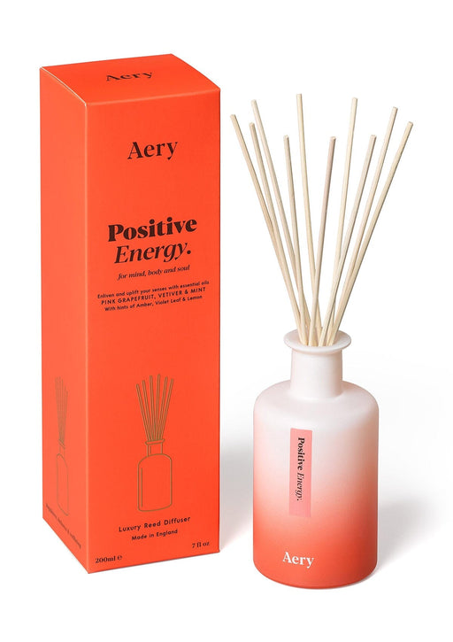 Red Positive Energy Diffuser by Aery displayed next to product packaging on white background 