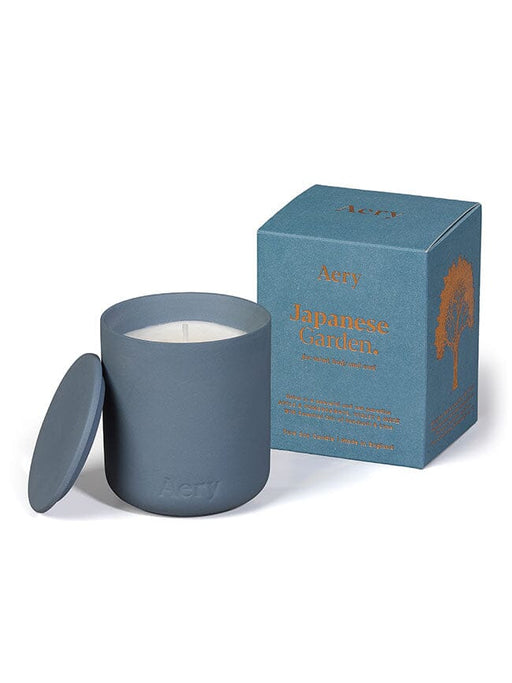 Blue Japanese Garden candle by Aery displayed next to product packaging on white background 