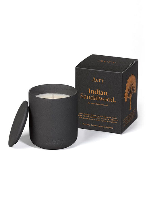 Black Indian Sandalwood candle by Aery displayed next to product packaging on white background 