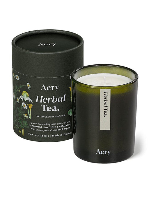 Green Herbal Tea candle by Aery displayed next to product packaging on white background 