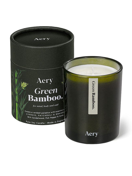 Green Bamboo candle by Aery displayed next to product packaging on white bacground 