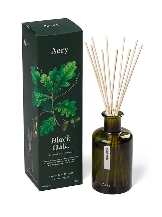 Green Black Oak diffuser by Aery displayed next to product packaging on white background 