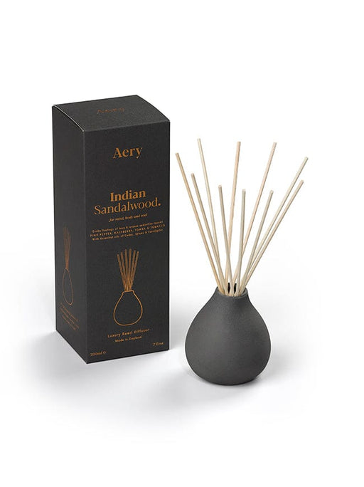 Black Indian Sandalwood diffuser by Aery displayed next to product packaging on white background 