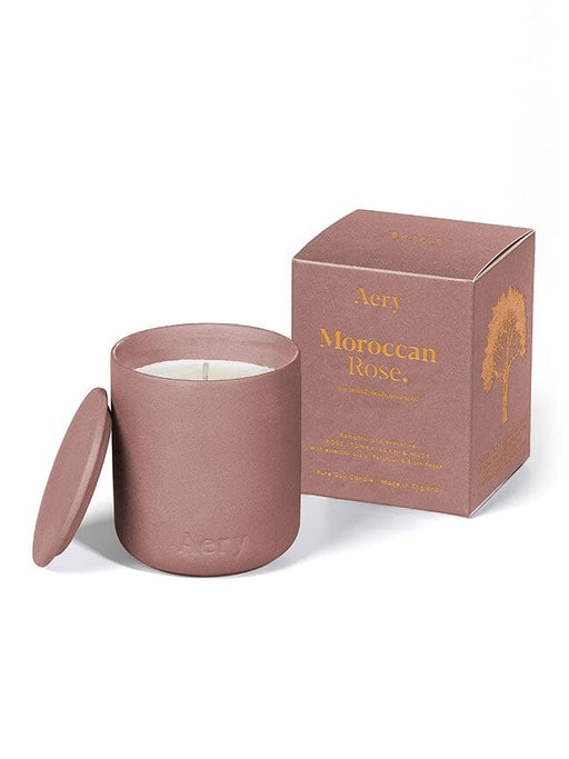 Aubergine Moroccan Rose candle by Aery displayed next to product packaging on white bacground 