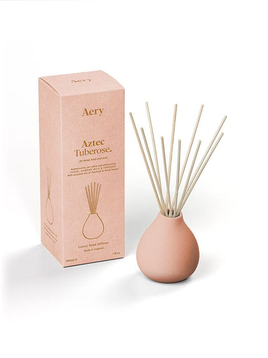 Pink Aztec Tuberose diffuser by Aery displayed next to product packaging on white background 