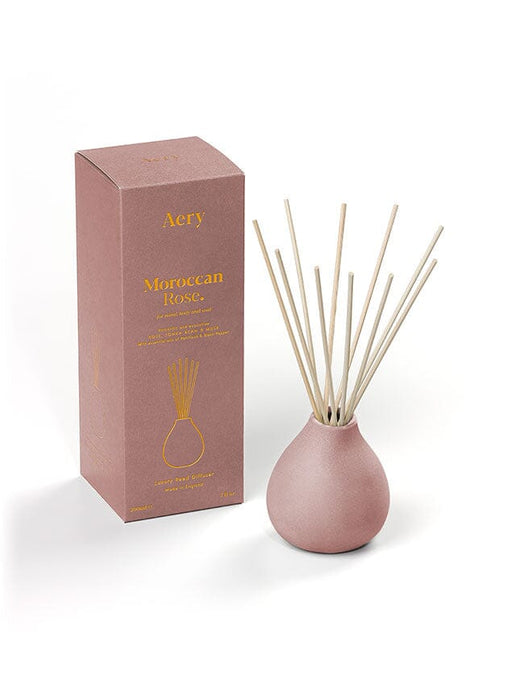 Aubergine Moroccan Rose diffuser by Aery displayed next to product packaging on white bacground 