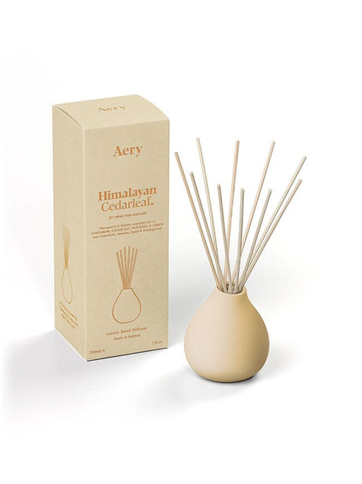 Cream Himalayan Cedarleaf diffuser by Aery displayed next to product packaging on white background 