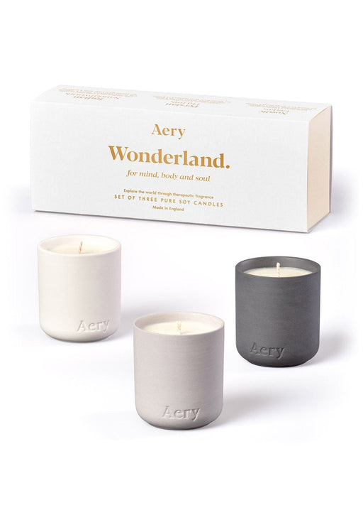 White Wonderland gift set of three mini candles by Aery displayed next to product packaging on white background 