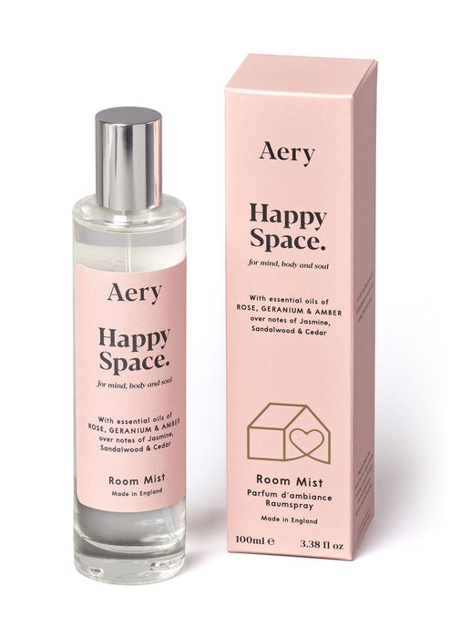 Pink Happy Space Room Mist by Aery displayed next to product packaging on white bacground 