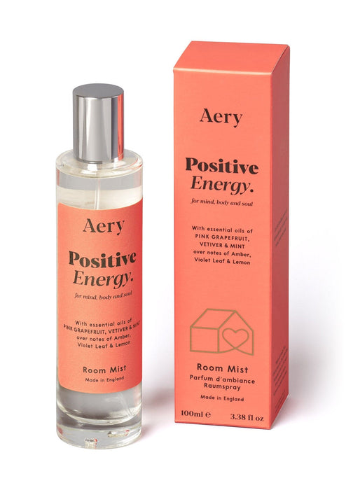 Orange Positive Energy Room Mist displayed next to product packaging on white background  