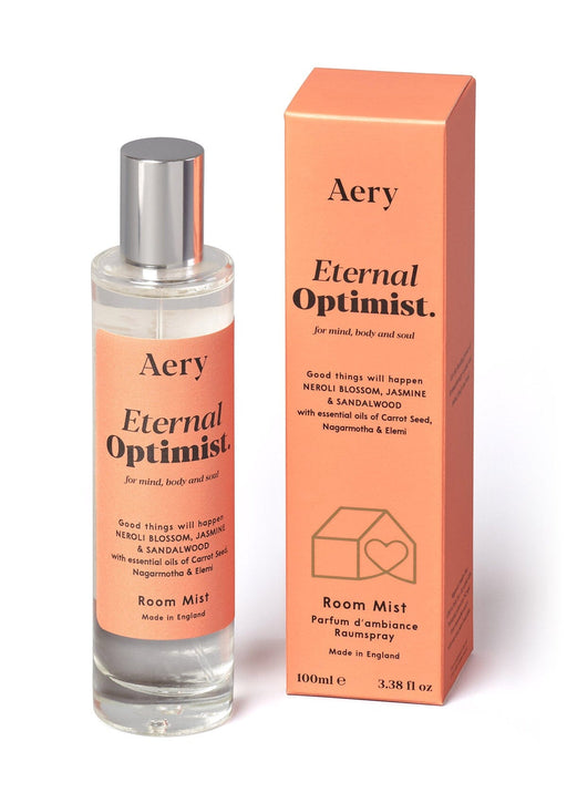 Orange Eternal Optimist Room Mist by Aery displayed next to product packaging on white bacground 