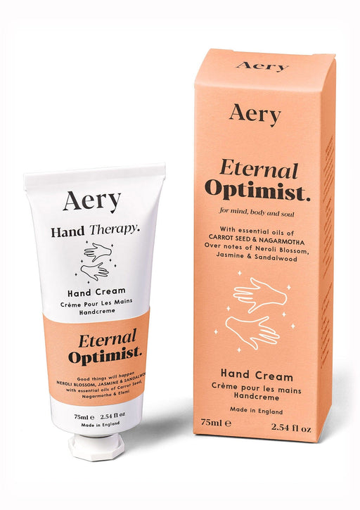 Orange Eternal Optimist hand cream by Aery displayed next to product packing on white bacground 