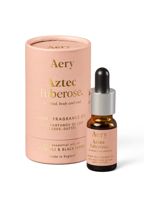 Pink Aztec Tuberose fragrance oil by Aery displayed next to product packaging  on white bacground