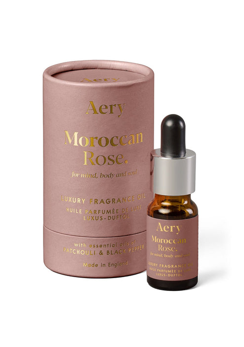 Aubergine Moroccan Rose fragrance oil by Aery displayed next to product packaging on white background 