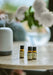 Light Botanical fragrance oils sat on cream table 