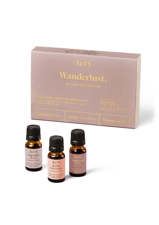 Wanderlust set of three fragrance oils by Aery displayed next to product packaging on white background 