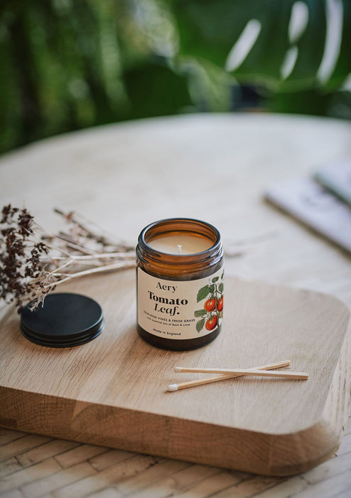 Tomato Leaf jar candle by Aery on wooden tray with match sticks