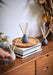 Blue Japanese Garden diffuser by aery displayed on wooden side table 