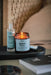 Blue before sleep jar candle by aery displayed next to before sleep pillow mist sat on black tray on bedside table 