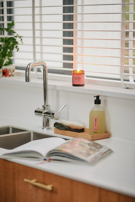 Positive energy Hand Wash placed by kitchen sink 