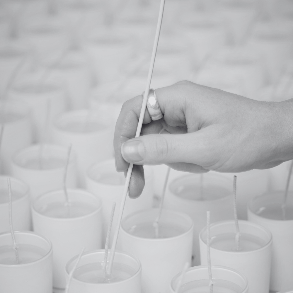 hand centreing wicks in candle after second pour