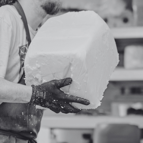 person holding large block of wax ready to melt